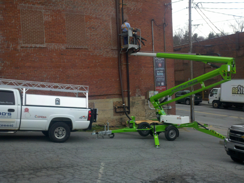Using a lift to safely install 40' elevation refrigeration lines.