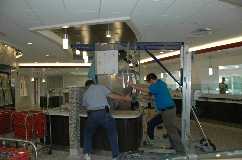 Installation of Follett soda and ice dispenser at ASU, using a custom in house built installation bracket